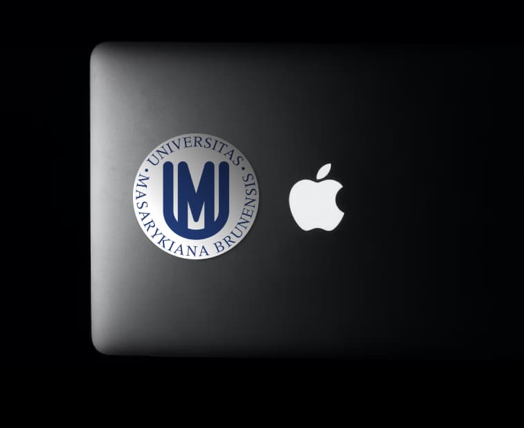 Macbook with Masaryk University logo badge on the back.